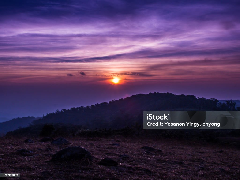 The sun rises between the cloud and mountainn in Mon Jong. The sun rises between the cloud and mountainn in Mon Jong, Chiangmai, Thailand. Above Stock Photo