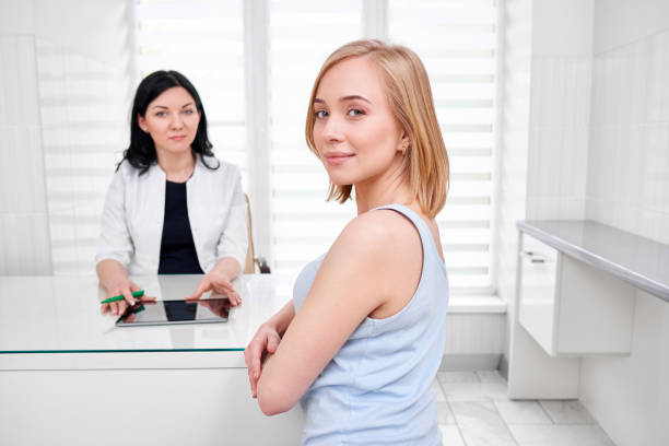 istock Beautiful young woman visiting doctor 695962872