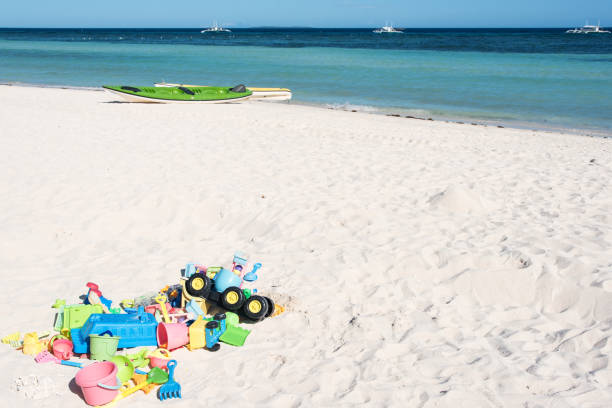 istock Children's sand toys on tropical beach 695968112