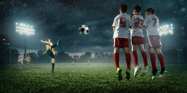 istock Soccer kids player makes a free kick 695970602