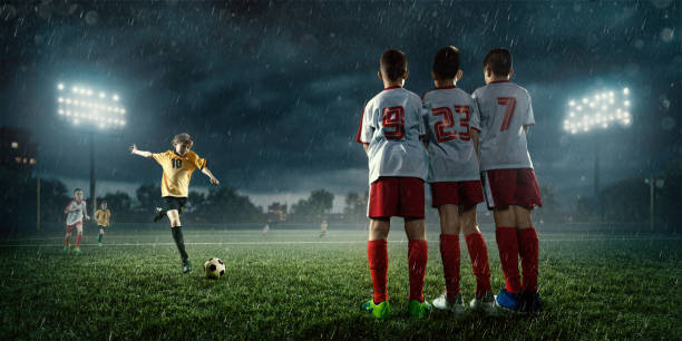 istock Soccer kids player makes a free kick 695970650