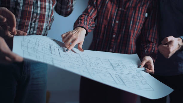 istock The group of designers discussing blueprints 695971266