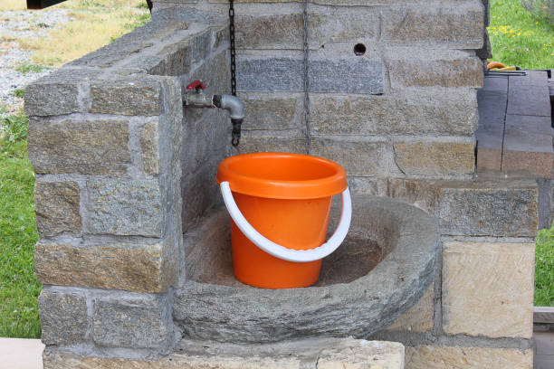 a plastic bucket in stone sink