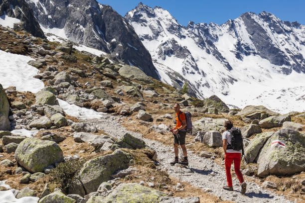istock Hikers are walking on high mountain trail 695979128
