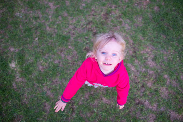 Baby girl, looking up, high angle shot, blond girl