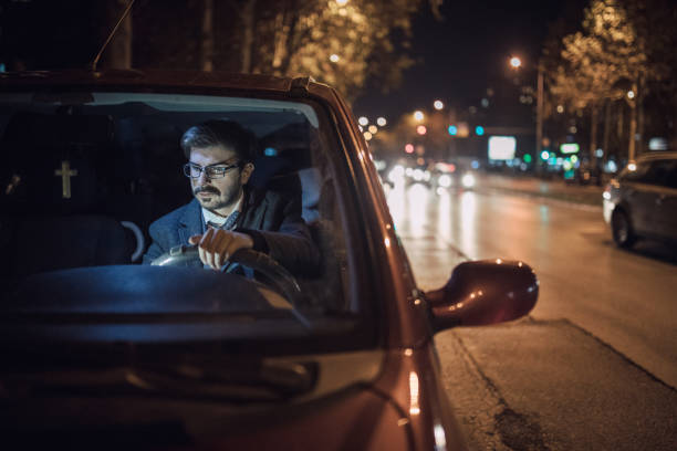 istock Businessman driving at night 695984232