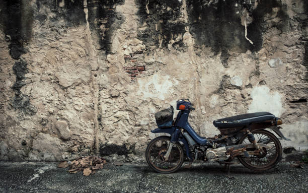 istock Old motorcyle with Old wall texture background  in Bangkok, Thailand 695984266
