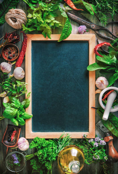 Fresh kitchen herbs and spices on wooden table Fresh kitchen herbs and spices on wooden table with a blackboard. Top view mezzaluna stock pictures, royalty-free photos & images