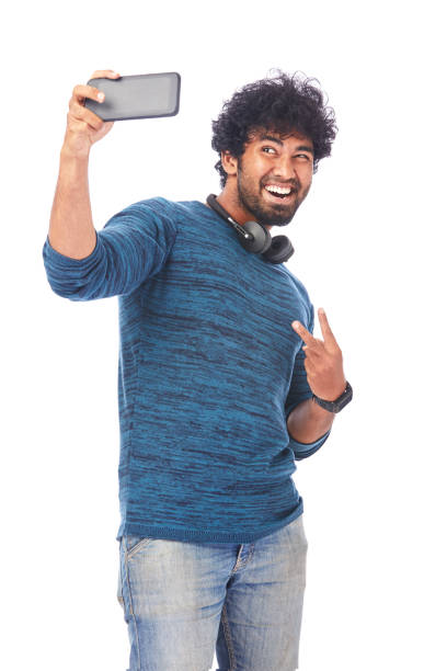 istock Cheerful young man taking selfie with latest smart phone 695987616
