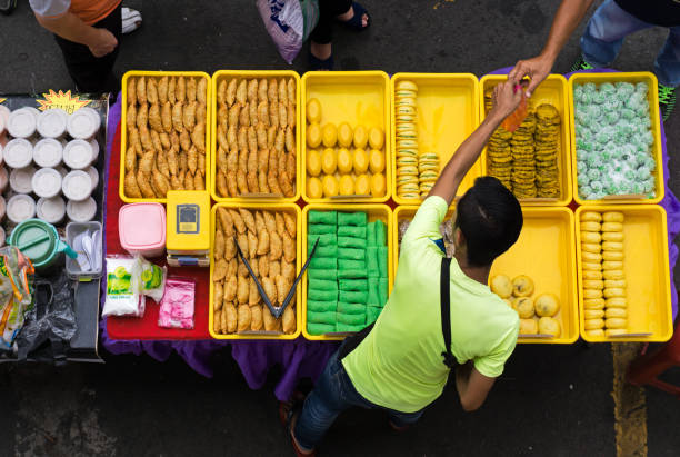 Top view of vendor owner selling variety of cakes and dessert Kota Kinabalu, Malaysia - June 10, 2015: Top view of vendor owner selling small business malaysia stock pictures, royalty-free photos & images