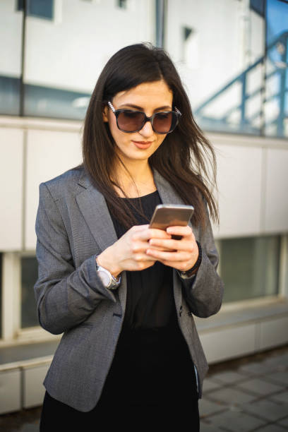 istock Young businesswoman using mobile phone 695995322