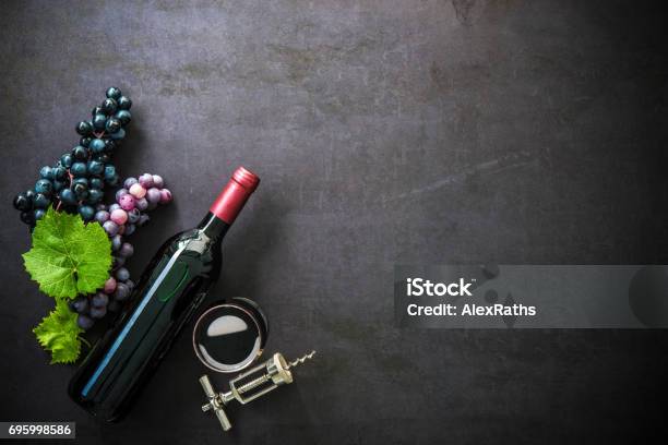 Bottle Of Red Wine Wineglass And Grapes Stock Photo - Download Image Now - Wine, Table, Backgrounds