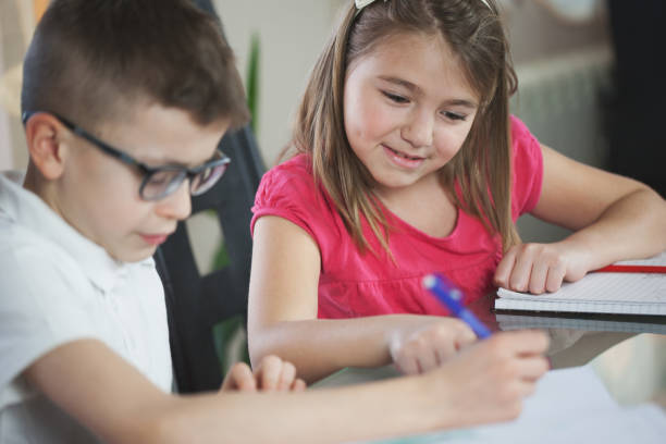 istock Beautiful schoolgirl doing homework at home 696004664