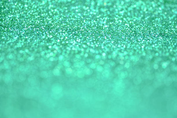 istock Bright and abstract blurred green bokeh background with shimmering glitter 696004832