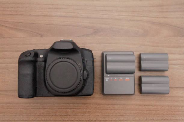 istock Camera with charger and batteries 696006274
