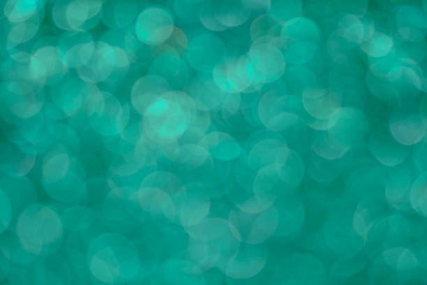 istock Bright and abstract blurred green bokeh background with shimmering glitter 696007142