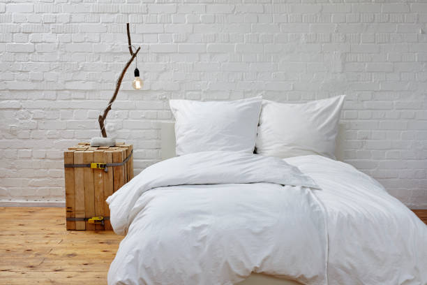 istock minimalistic bedroom white linen and branch lamp 696009356