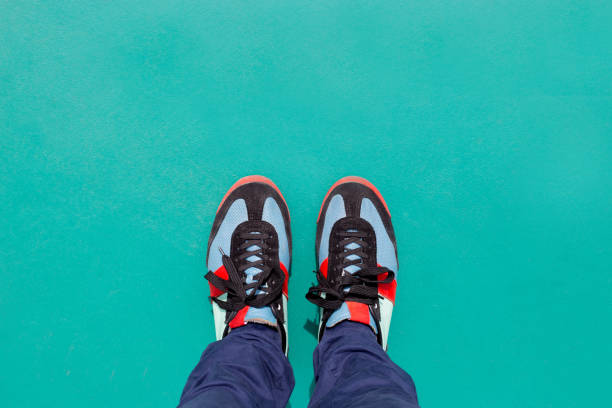 istock Top view of colored sneakers on green ground 696018774