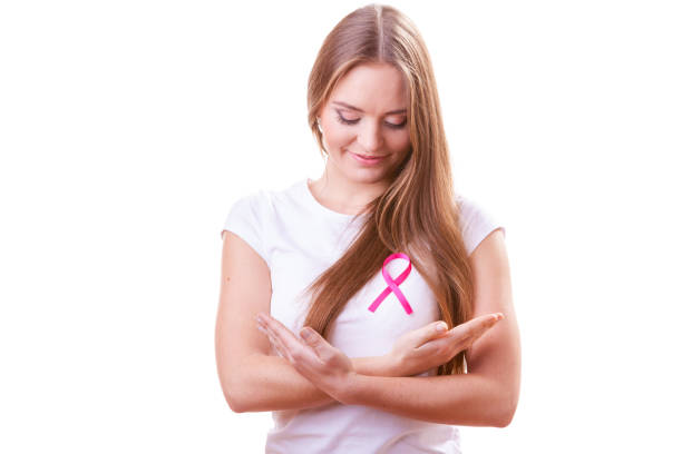 Woman wih pink cancer ribbon on chest stock photo