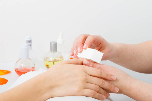 istock Preparing nails before manicure, beautician file nails 696021580