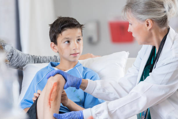 istock Senior ER doctor asks young athlete questions 696021852