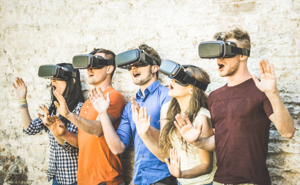 istock Friends group playing on vr glasses outdoors - Virtual reality and wearable tech concept with young people having fun together with headset goggles - Digital generation trends - Retro contrast filter 696022942