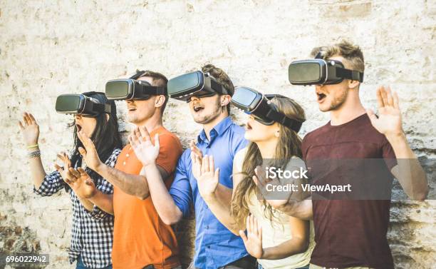 Friends Group Playing On Vr Glasses Outdoors Virtual Reality And Wearable Tech Concept With Young People Having Fun Together With Headset Goggles Digital Generation Trends Retro Contrast Filter Stock Photo - Download Image Now