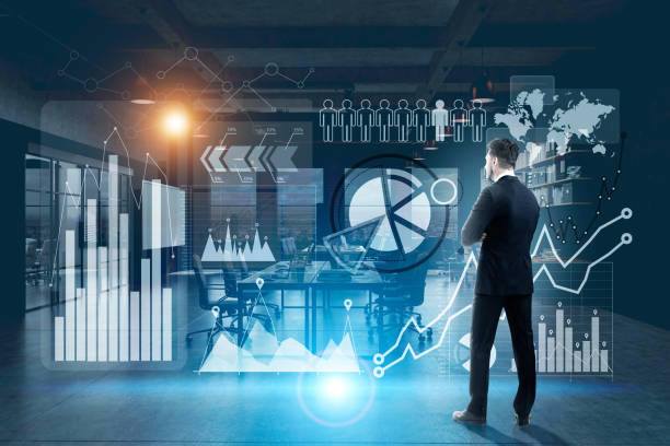 istock Businessman in suit in a blue office, graphs 696025674