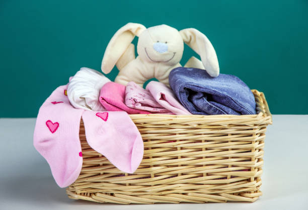 istock Baby clothes in a wicker basket 696025748
