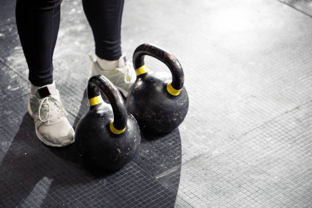 istock Kettlebell on floor. Girl training in gym 696032500