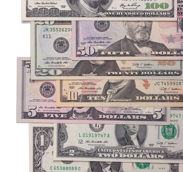 istock US american dollar money bills isolated on white background. 696035632