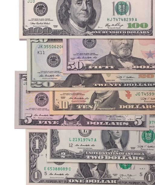istock US american dollar money bills isolated on white background. 696038702