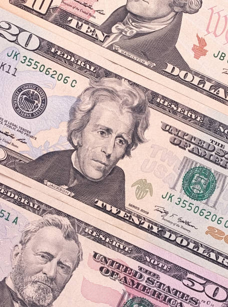 istock American dollar bills of different denominations abstract background. 696039106