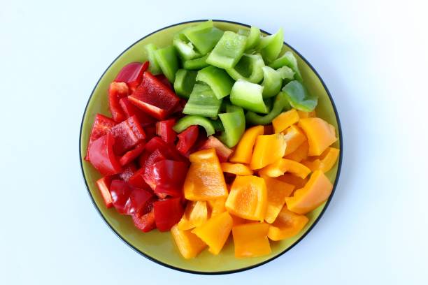 istock a plate filled with peppers with three colors fresh and cut 696039516