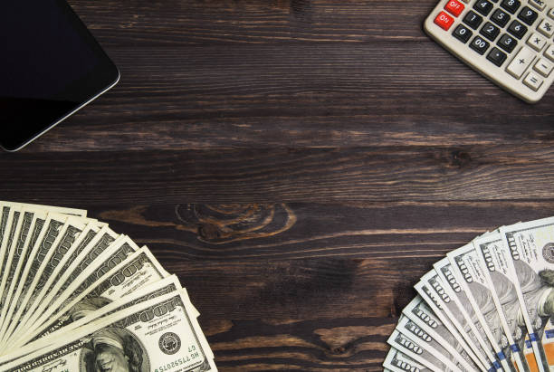 istock Dollars on a wooden background. dollar top view 696049056