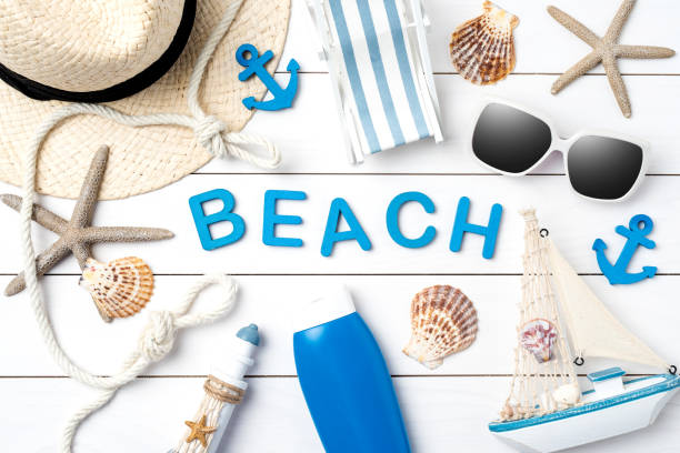 istock Beach accessories on white wooden table. 696052960