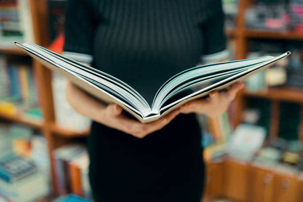 A young student reads a very interesting book in the library