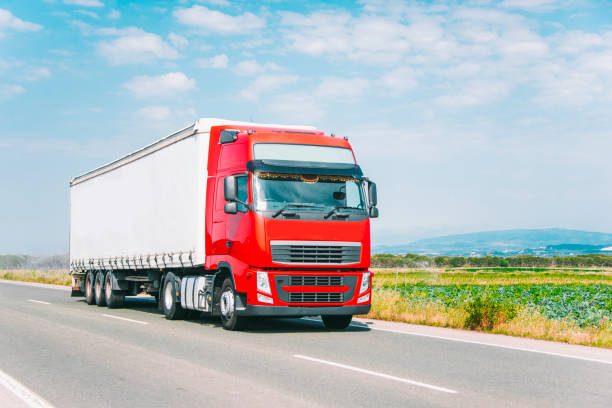 istock Red truck on road 696059172