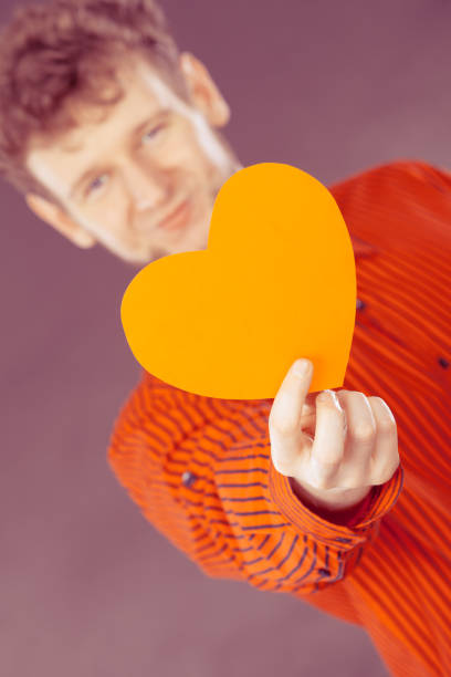 istock Boy in love with red heart. 696062502