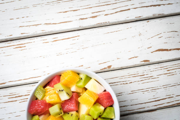 istock Fresh fruit salad on an old white wooden table 696062852