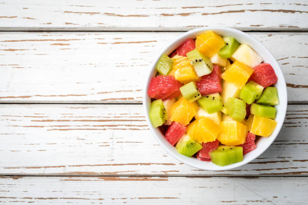 istock Fresh fruit salad on an old white wooden table 696067118