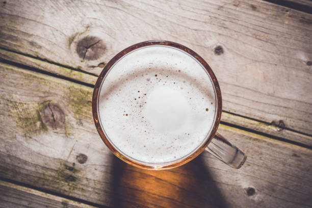 istock Beer mug on an old wooden table. 696067300