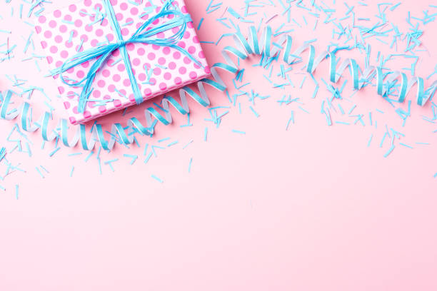 istock Birthday background with pink dotted gift box, serpentine and confetti. 696067416
