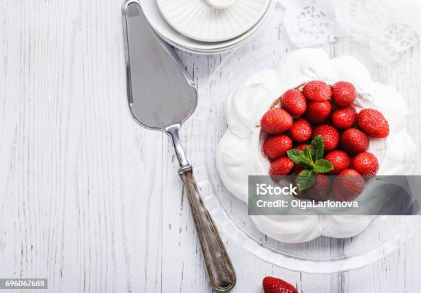Pavlova Meringue Cake With Fresh Strawberries On White Wood Background Close Up Selective Focus Stock Photo - Download Image Now