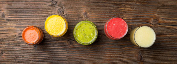istock Fresh juices on an old wooden table 696067754