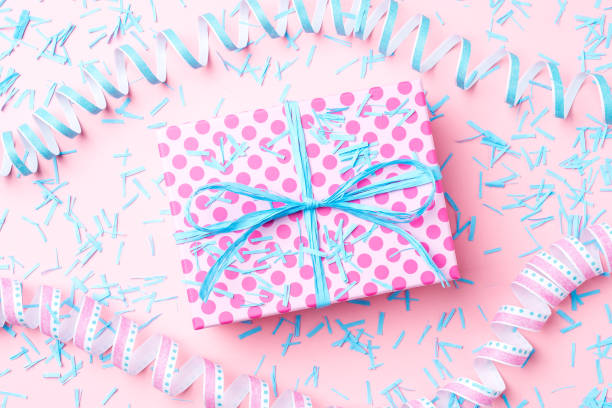istock Birthday background with pink dotted gift box, serpentine and confetti. 696069994