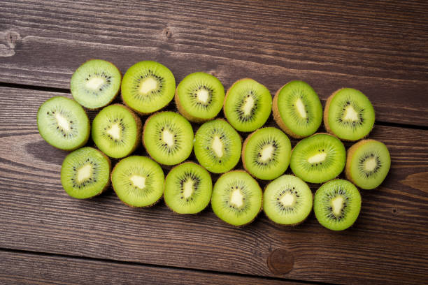 istock Halves of kiwi fruit on wooden table. 696070076