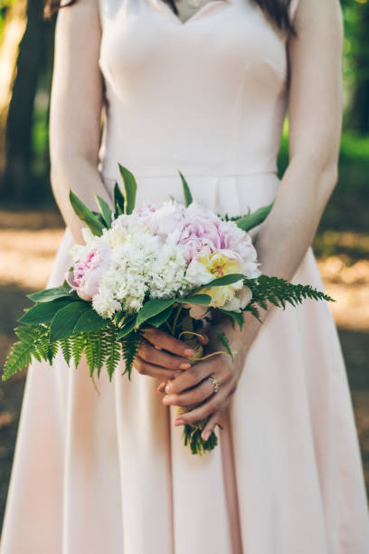 istock woman with bouquet close up 696070506