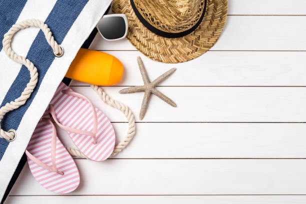 istock Beach accessories on white wooden table. 696070918