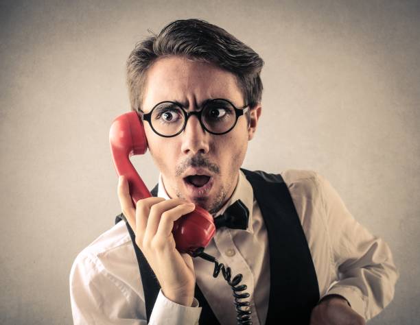 istock Man with a red, retro phone 696071548